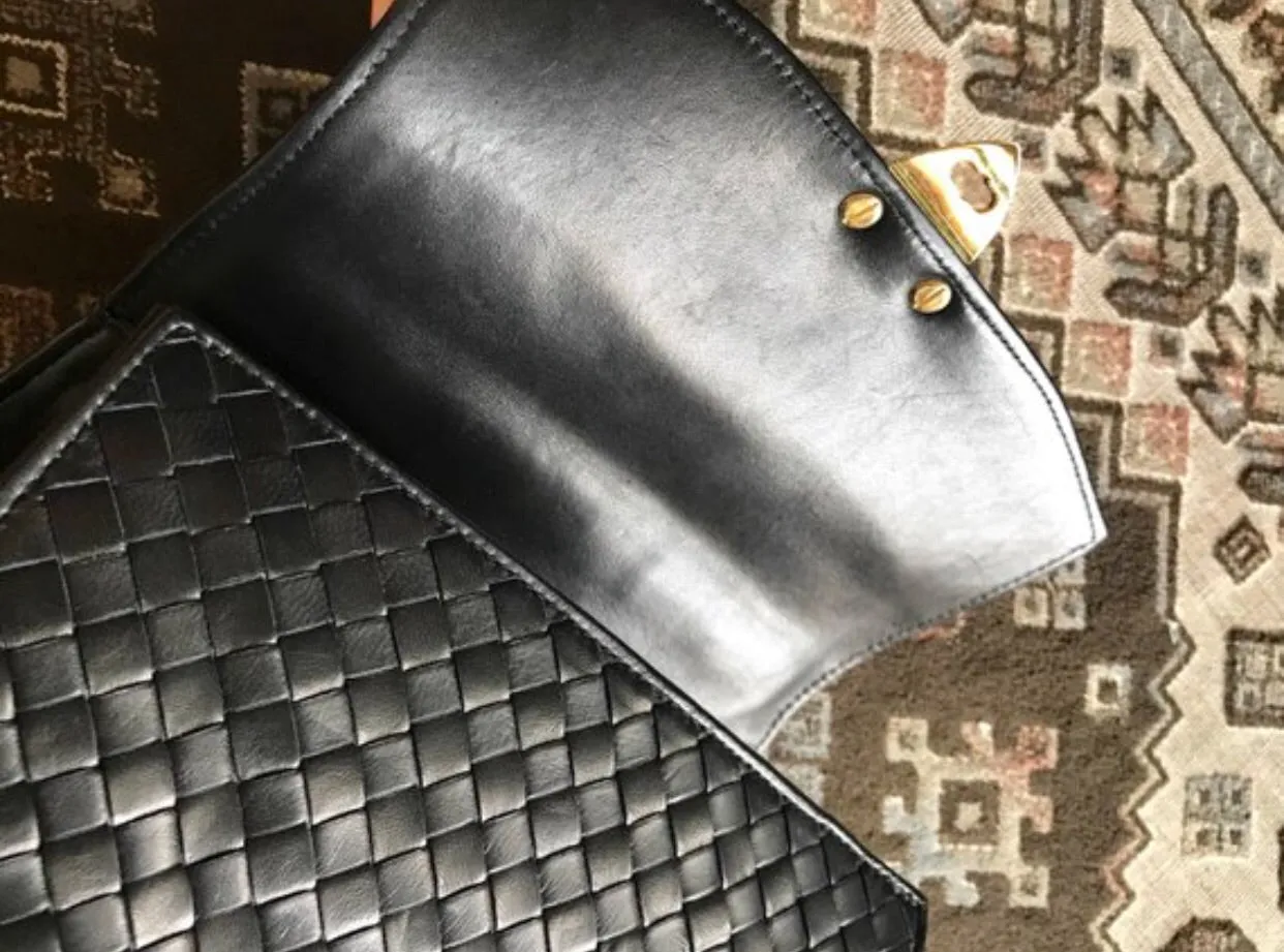 1990s. Vintage Bottega Veneta classic black lamb leather intrecciato handbag with golden closure hock. Gorgeous masterpiece from Bottega.