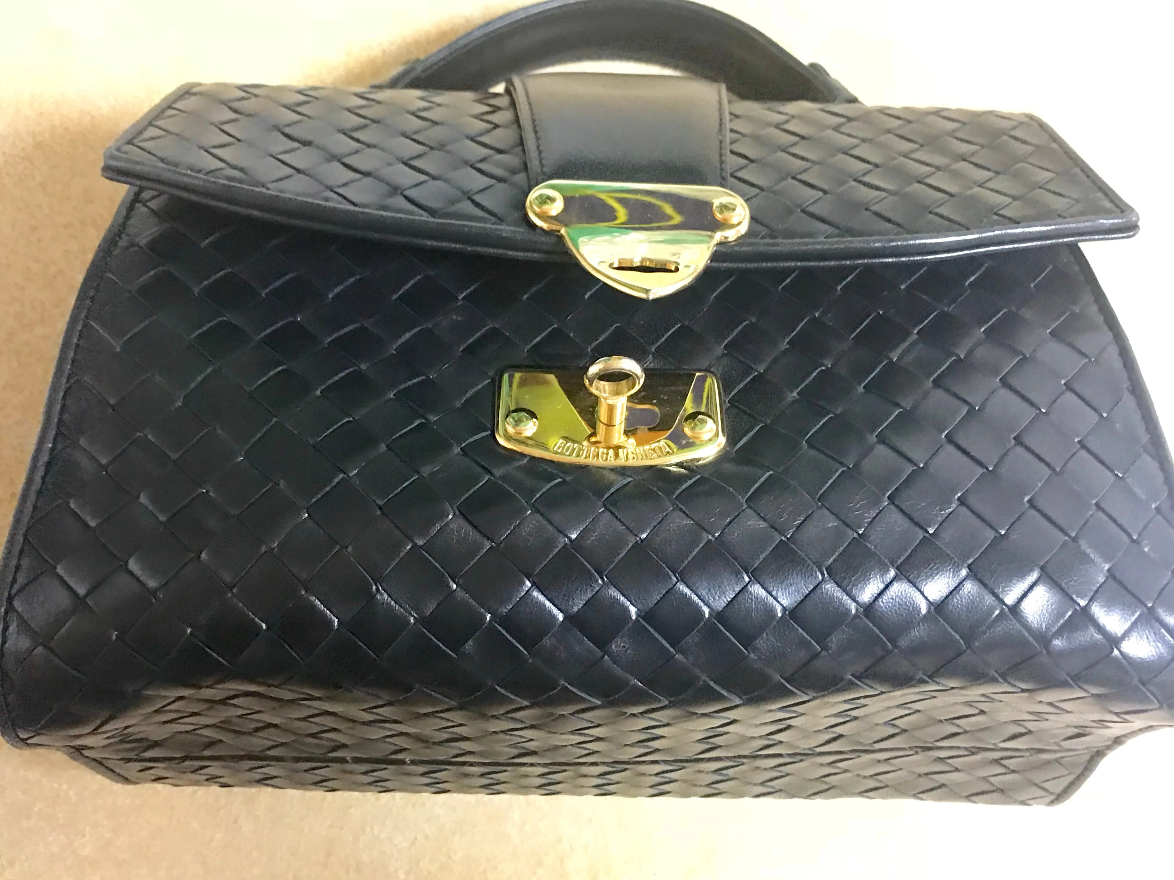 1990s. Vintage Bottega Veneta classic black lamb leather intrecciato handbag with golden closure hock. Gorgeous masterpiece from Bottega.