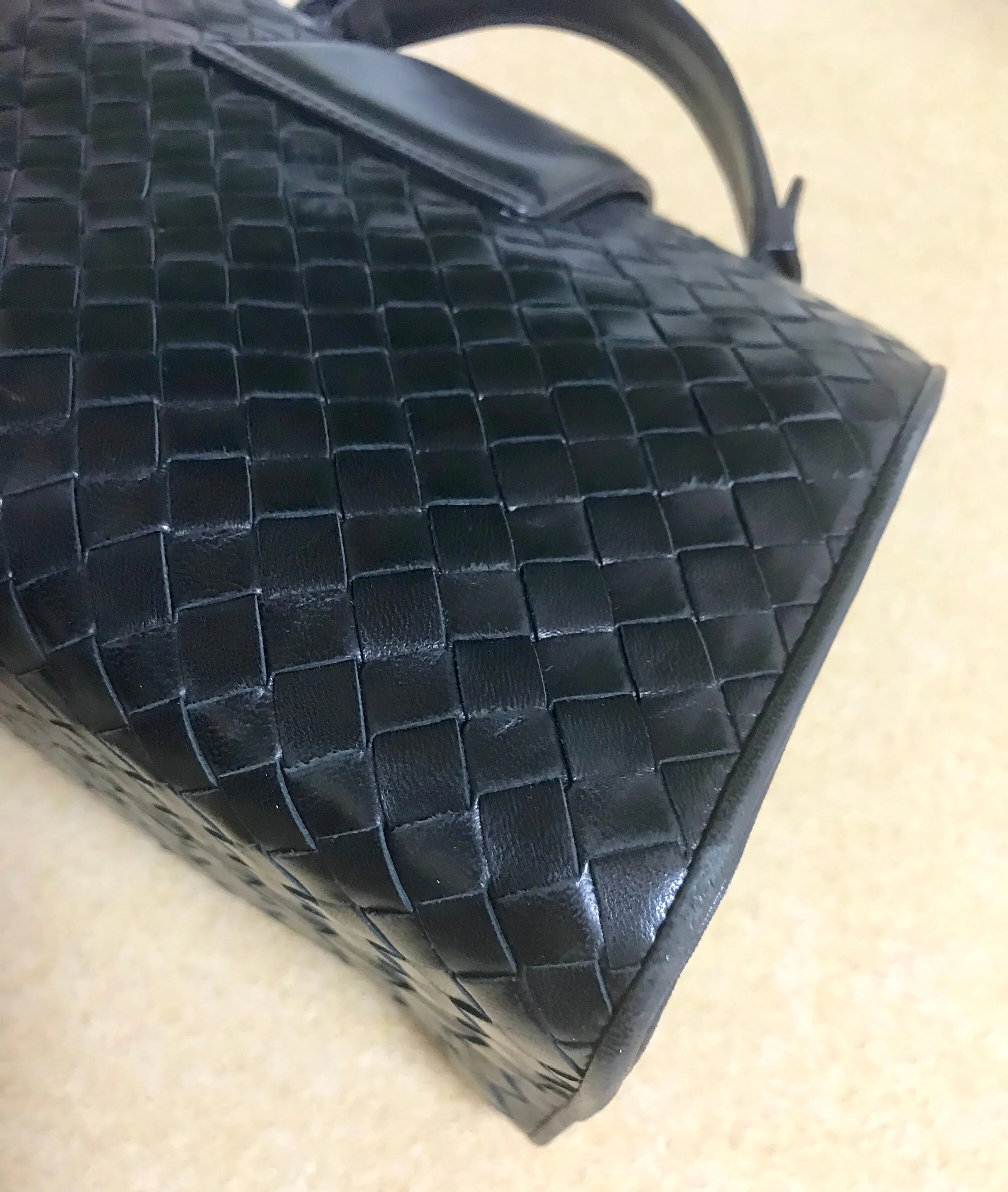 1990s. Vintage Bottega Veneta classic black lamb leather intrecciato handbag with golden closure hock. Gorgeous masterpiece from Bottega.