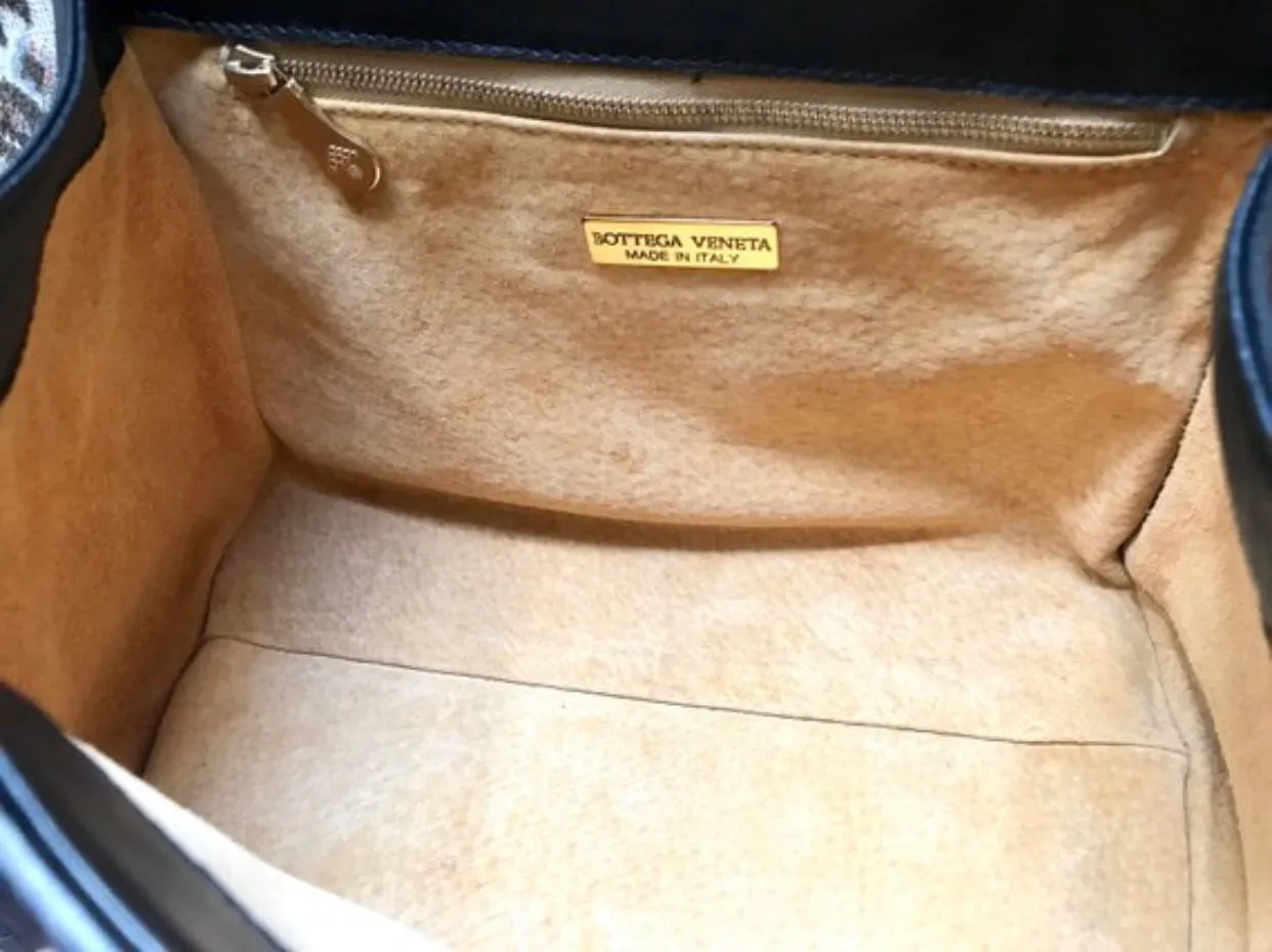 1990s. Vintage Bottega Veneta classic black lamb leather intrecciato handbag with golden closure hock. Gorgeous masterpiece from Bottega.
