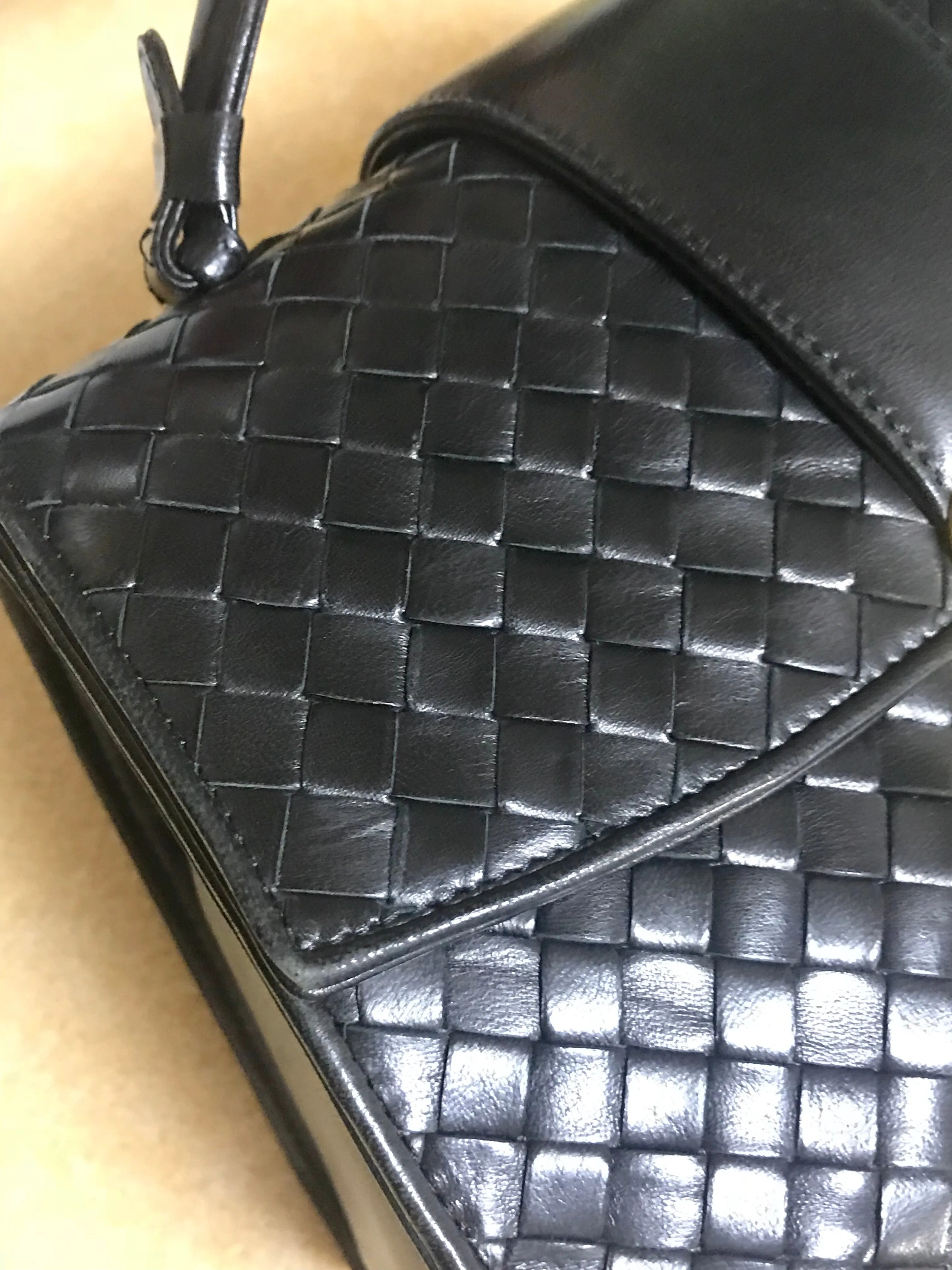 1990s. Vintage Bottega Veneta classic black lamb leather intrecciato handbag with golden closure hock. Gorgeous masterpiece from Bottega.