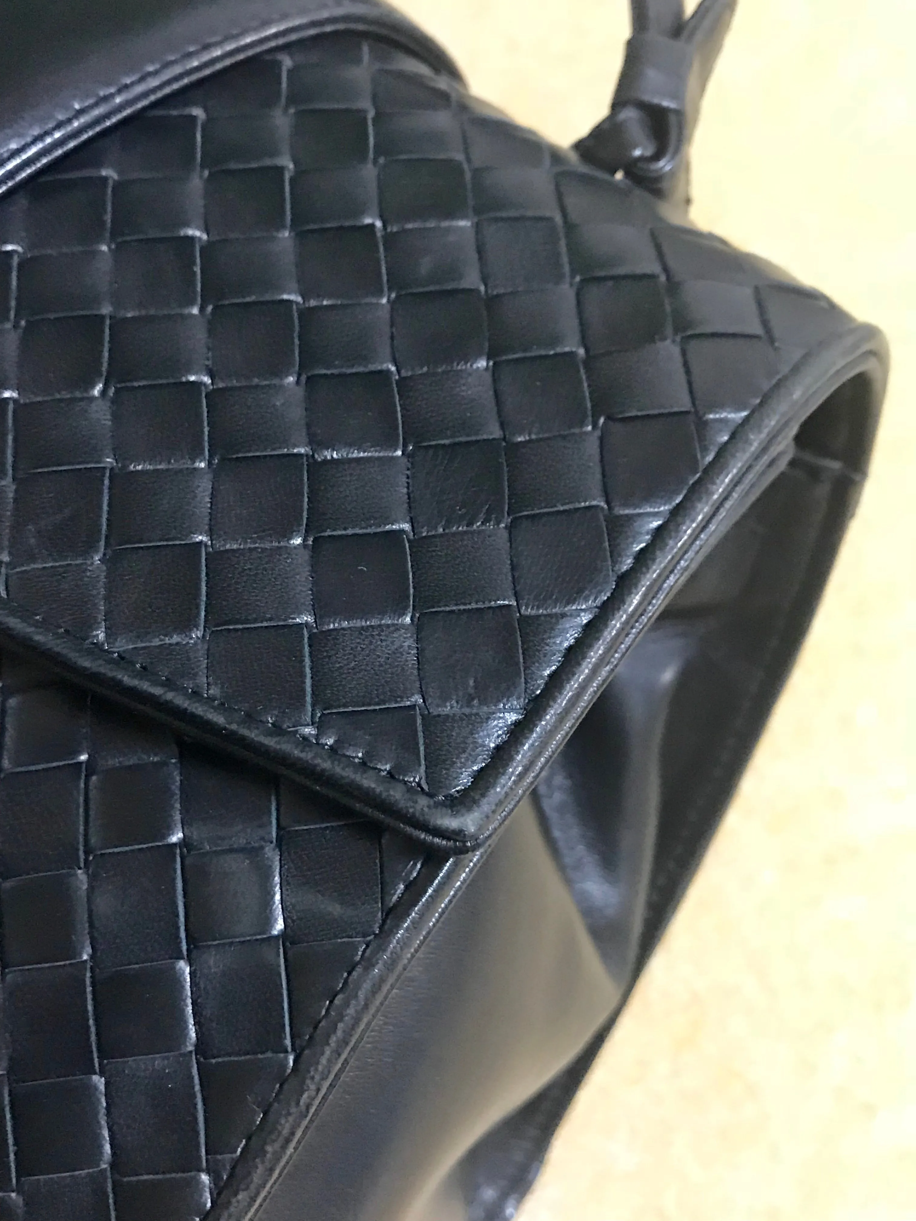 1990s. Vintage Bottega Veneta classic black lamb leather intrecciato handbag with golden closure hock. Gorgeous masterpiece from Bottega.