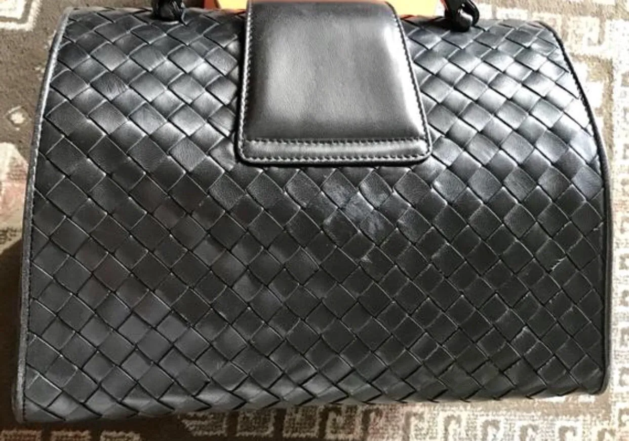 1990s. Vintage Bottega Veneta classic black lamb leather intrecciato handbag with golden closure hock. Gorgeous masterpiece from Bottega.