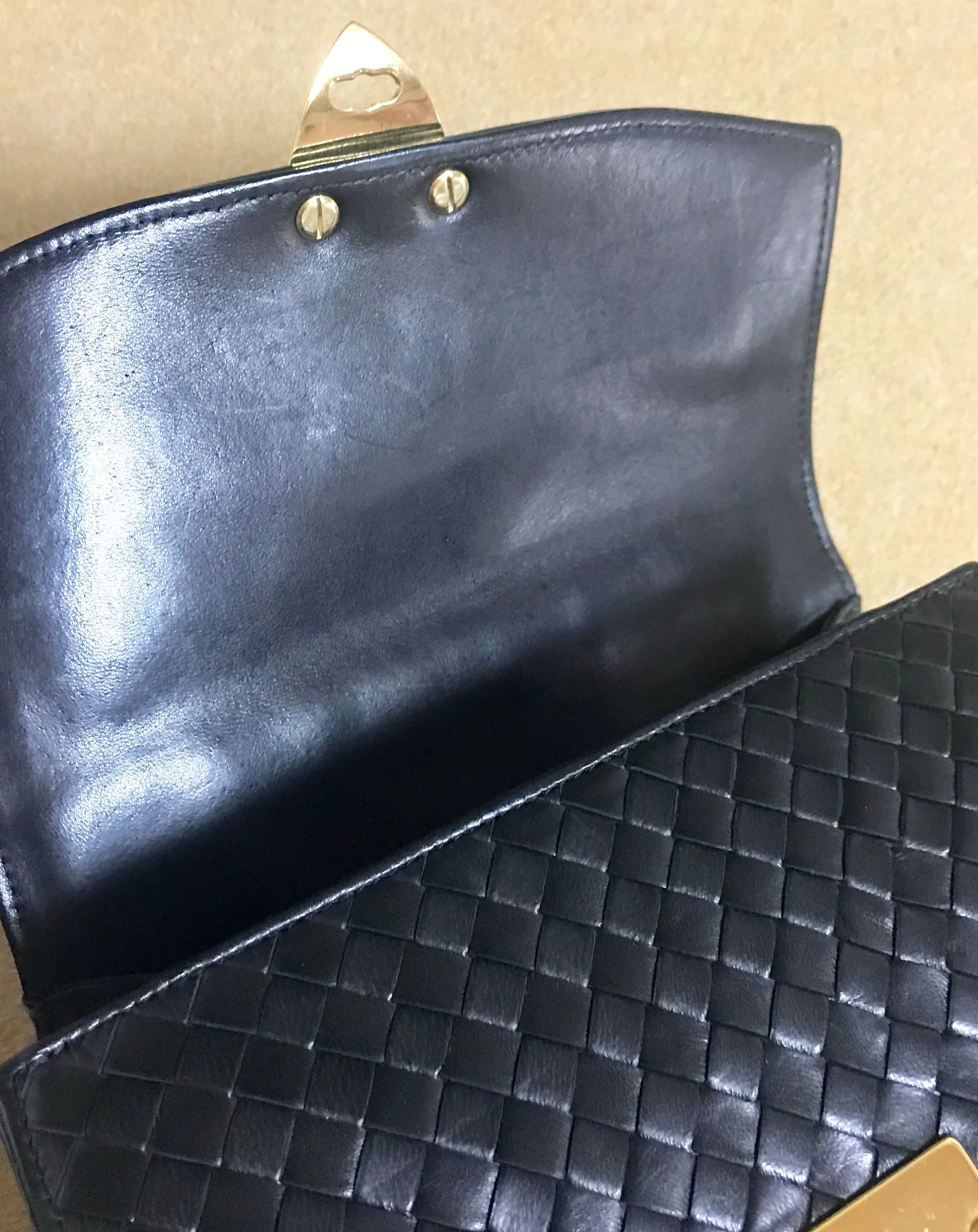 1990s. Vintage Bottega Veneta classic black lamb leather intrecciato handbag with golden closure hock. Gorgeous masterpiece from Bottega.