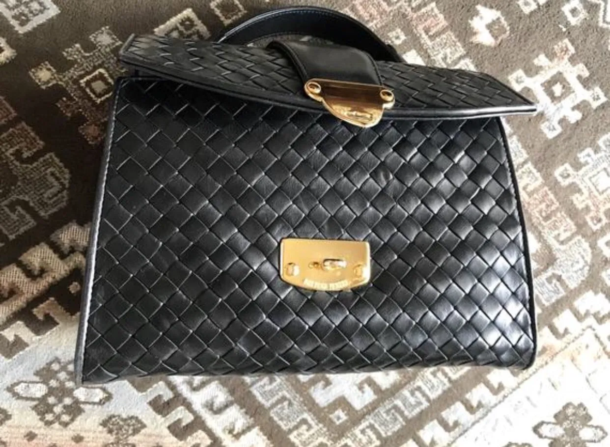 1990s. Vintage Bottega Veneta classic black lamb leather intrecciato handbag with golden closure hock. Gorgeous masterpiece from Bottega.