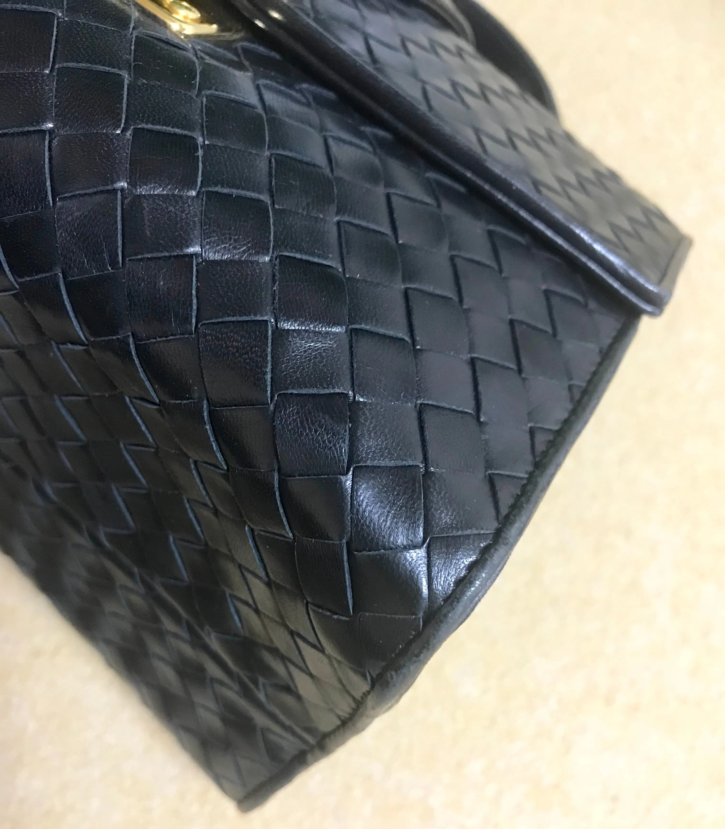 1990s. Vintage Bottega Veneta classic black lamb leather intrecciato handbag with golden closure hock. Gorgeous masterpiece from Bottega.