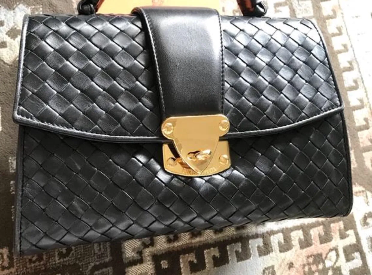 1990s. Vintage Bottega Veneta classic black lamb leather intrecciato handbag with golden closure hock. Gorgeous masterpiece from Bottega.