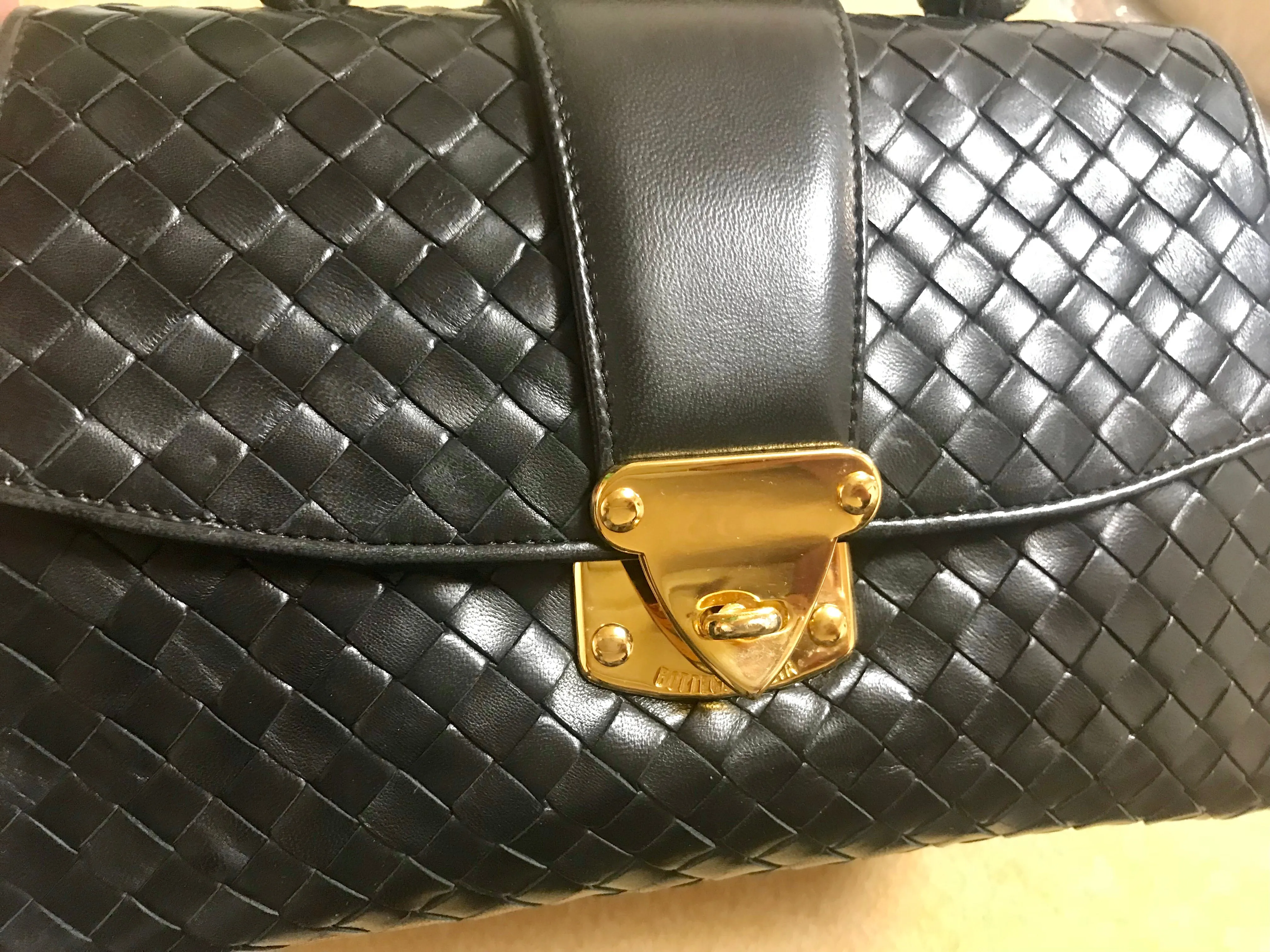 1990s. Vintage Bottega Veneta classic black lamb leather intrecciato handbag with golden closure hock. Gorgeous masterpiece from Bottega.