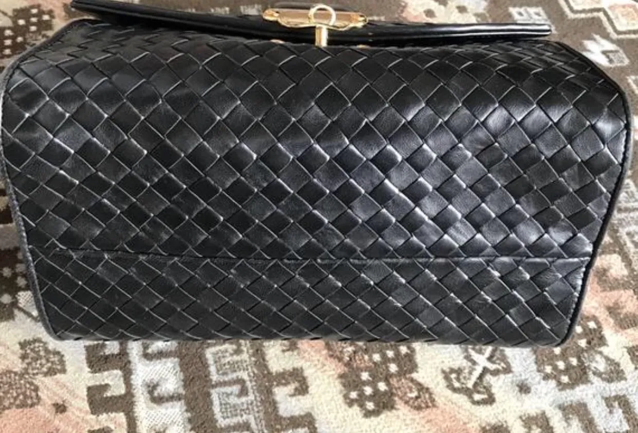 1990s. Vintage Bottega Veneta classic black lamb leather intrecciato handbag with golden closure hock. Gorgeous masterpiece from Bottega.