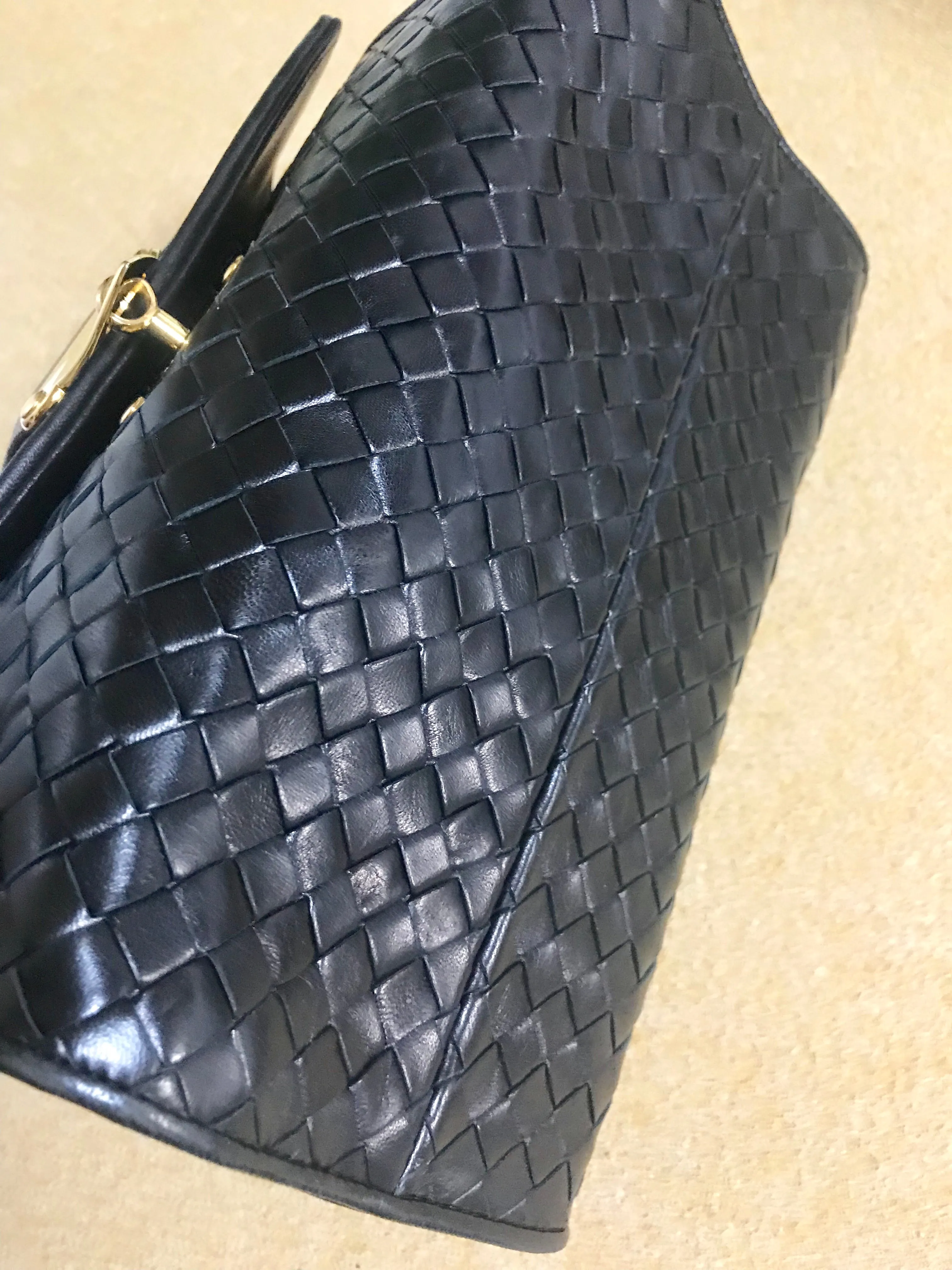 1990s. Vintage Bottega Veneta classic black lamb leather intrecciato handbag with golden closure hock. Gorgeous masterpiece from Bottega.