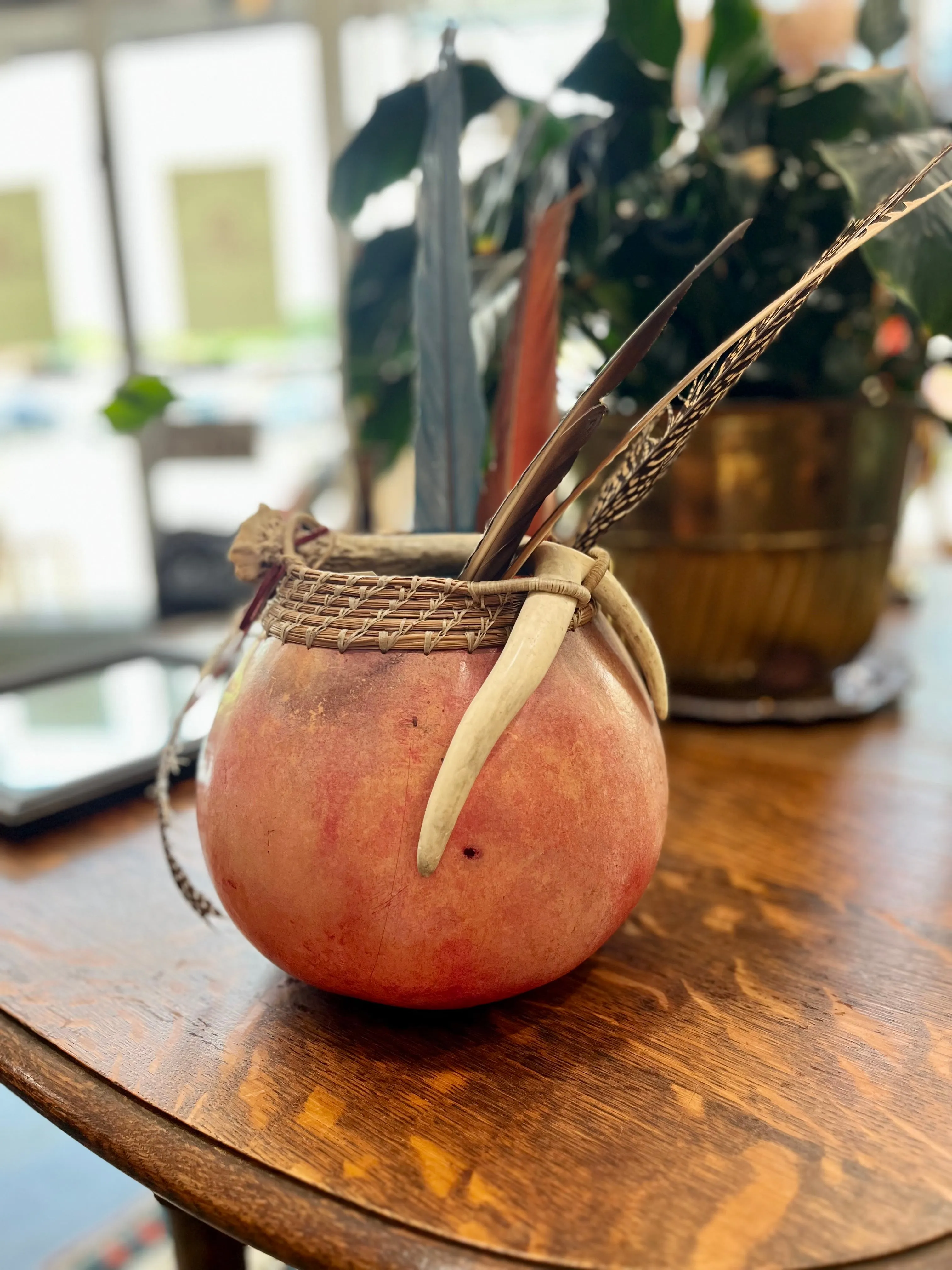 Ceremonial gourd with feathers