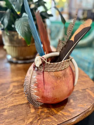 Ceremonial gourd with feathers